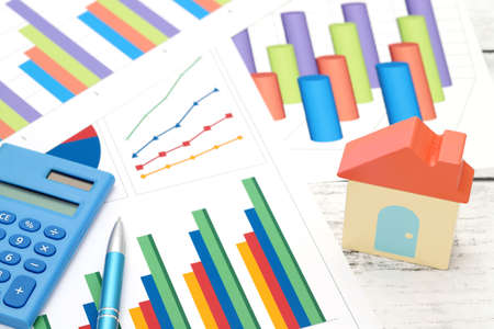 toy house and color chart printed documents, calculator on the tableの写真素材