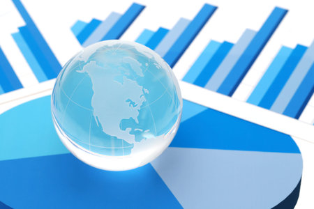 Glass globe of North and South America with graph printed documentsの写真素材