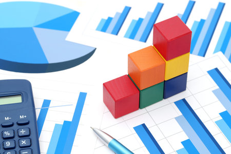 colorful wooden blocks with chart printed documents on white background