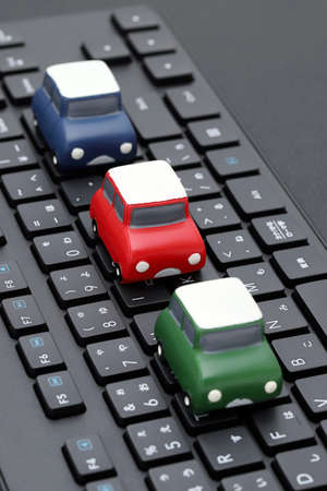 Small toy car on Alphabetics and Japanese hiragana typing keyboardの写真素材
