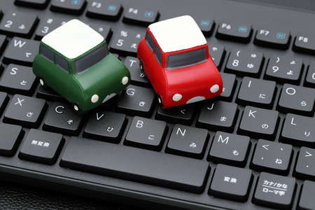 Small toy car on Alphabetics and Japanese hiragana typing keyboardの写真素材