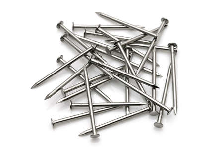 Pile of silver metallic nails isolated on white backgroundの写真素材