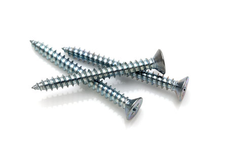 silver tapping screws isolated on white backgroundの写真素材