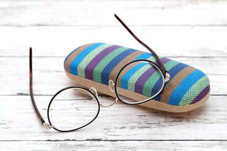 Stylish eyesight glasses and case for glasses on white wooden tableの写真素材