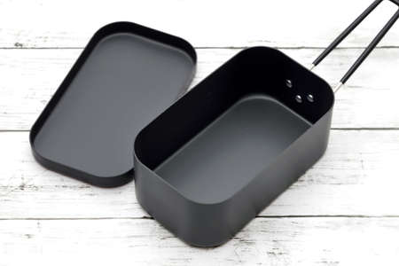 New camping tableware on a white painted wooden tableの写真素材