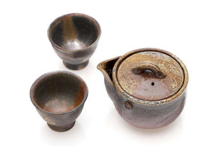Japanese green tea in a tea set with cup and pot isolated on a white backgroundの写真素材