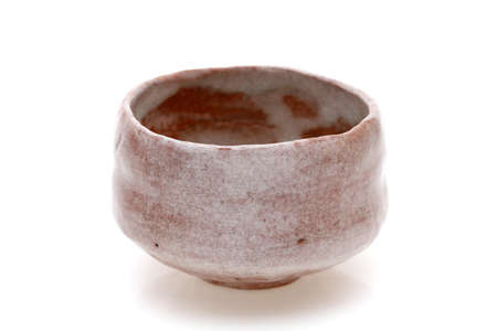 Single tea bowl used in Japanese matcha tea ceremony on white backgroundの写真素材