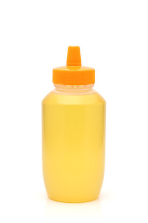 Plastic bottle of honey on white backgroundの写真素材