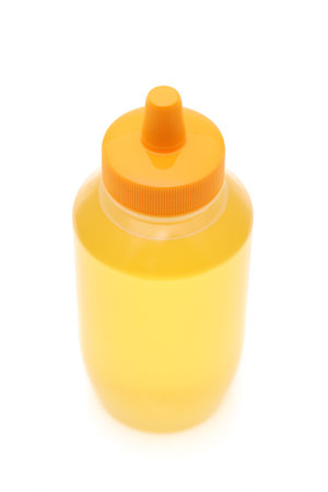 Plastic bottle of honey on white backgroundの写真素材