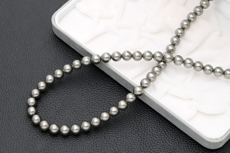 Elegant black pearl necklace on black backgroundの写真素材