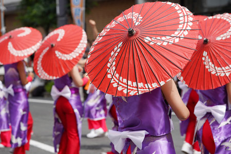 Japanese performers dancing in the famous Yosakoi Festival. Yosakoi is a unique style of Japanese dance event.の写真素材
