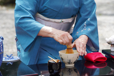 Japanese women in kimono prepares the macha green tea ceremony at gardenの写真素材