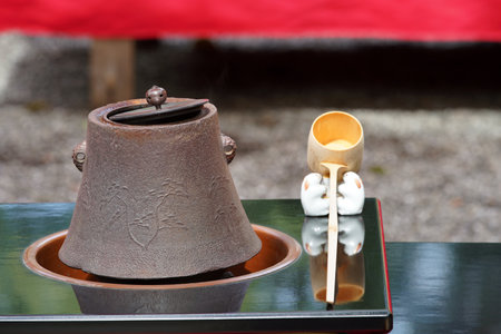 Traditional Japanese macha green tea ceremony, iron pot, ladle, outdoorsの写真素材