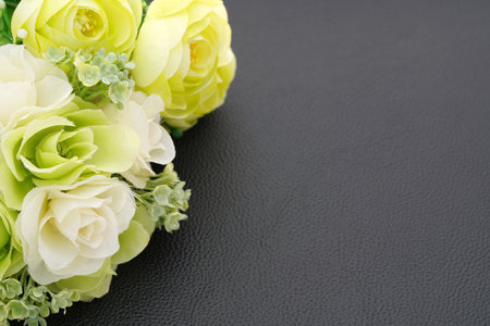 Closeup of the decorative bouquet of artificial white roses on the black backgroundの写真素材