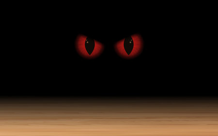 red eyes of on the wooden floor in the dark room