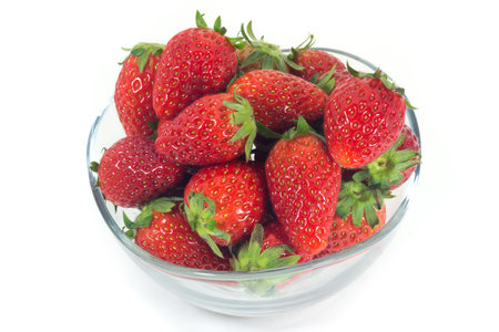 Strawberries in glass bowl isolated on white background (fruit)の写真素材