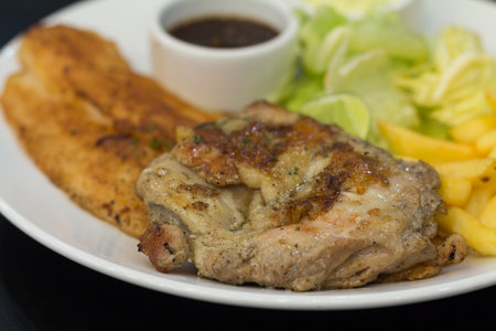 Grilled steak with chips and thai herb sauceの写真素材