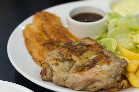 Grilled steak with chips and thai herb sauceの写真素材