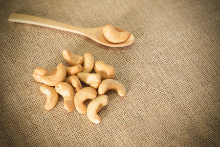 Roasted cashew nuts on wooden background soft focusの写真素材