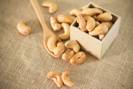 Roasted cashew nuts on wooden background soft focusの写真素材