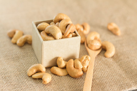 Roasted cashew nuts on wooden background soft focusの写真素材
