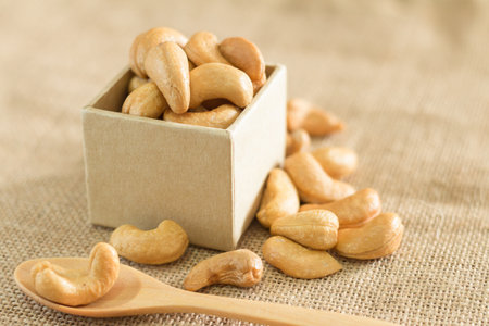 Roasted cashew nuts on wooden background soft focusの写真素材