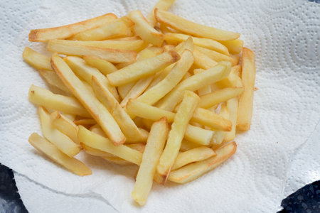 Crunchy French Fries on a paper plate with bright backgroundの写真素材