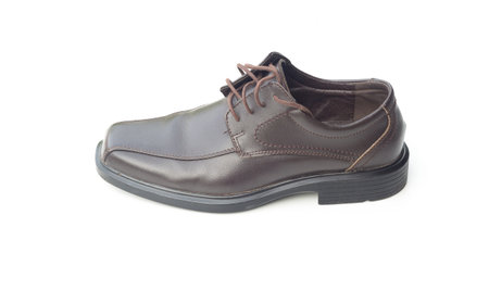 Dark brown leather men's shoes isolated on white backgroundの写真素材