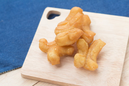 Chinese Traditional Snacks Deep Fried Doughstick Pa Tong Go on wooden plate.soft focusの写真素材