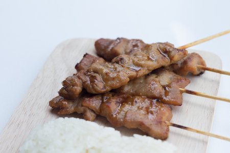 Grilled pork in asian style sticky rice that in Thailand is famous food for breakfast.selective focusの写真素材