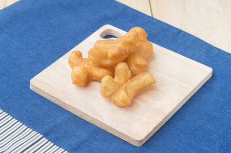 Chinese Traditional Snacks Deep Fried Doughstick Pa Tong Go on wooden plate.soft focusの写真素材