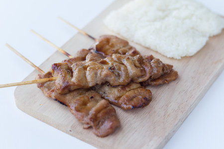 Grilled pork in asian style sticky rice that in Thailand is famous food for breakfast.selective focusの写真素材
