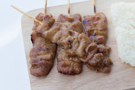 Grilled pork in asian style sticky rice that in Thailand is famous food for breakfast.selective focusの写真素材