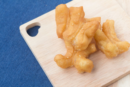 Chinese Traditional Snacks Deep Fried Doughstick Pa Tong Go on wooden plate.soft focusの写真素材
