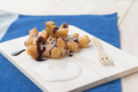 Chinese Traditional Snacks Deep Fried Doughstick Pa Tong Go that serve with sweetened condensed milk and chocolate syrup.soft focusの写真素材
