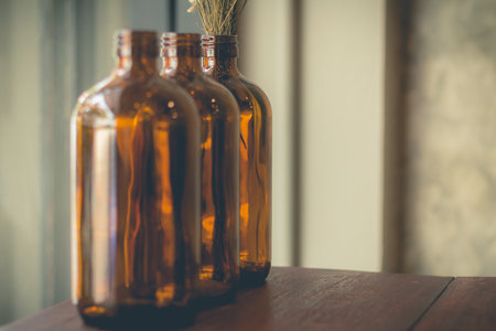 dried flowers in the brown glass use for decoration on the dining table (soft focus)の写真素材