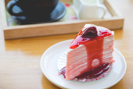 strawberry crape cake with strawberry sauce. strawberry crape cake in cozy outdoor cafe.(selective...