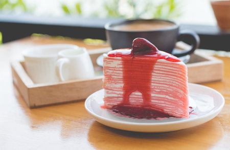 Strawberry crape cake with strawberry sauce. strawberry crape cake in cozy outdoor cafe.(selective focus, vintage effect)の写真素材