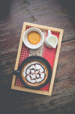 hot coffee with foam milk art. coffee mocha on the wood desk.(selective focus)の写真素材