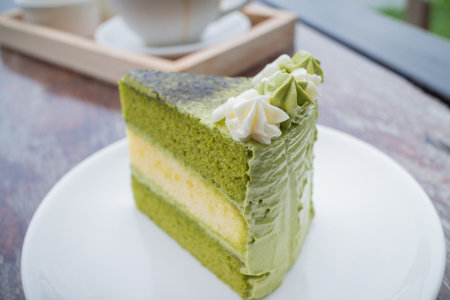 green tea cake with coffee breakfast set in outdoor restaurantの写真素材