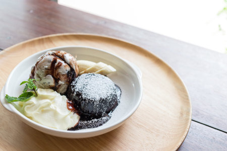 hot chocolate lava cake with vanilla ice cream ball, banana and whipped creamの写真素材