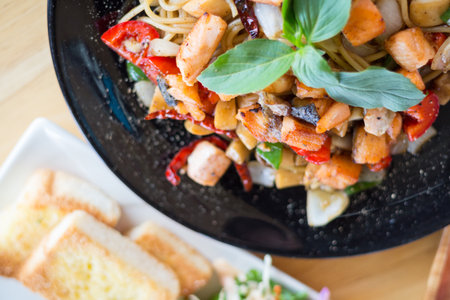 spicy herbal spaghetti with smoked salmon meat(selective focus)の写真素材