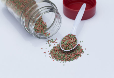 A heaping pile of pet fish food on a white backgroundの写真素材