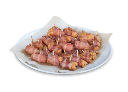Deep fried sausages rolled in bacon isolated on white backgroundの写真素材