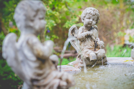 Statue of a beautiful little angle in the garden