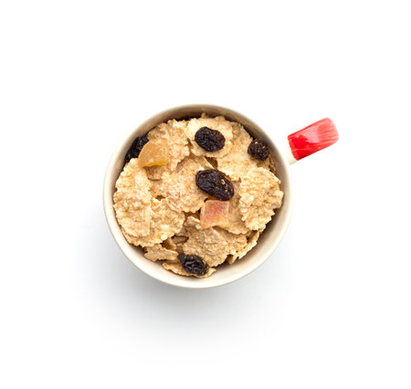 whole grain cereal flakes which mixed berry fruit and raisins for breakfast isolaed on white backgroundの写真素材