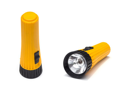yellow electric flashlight with simple design isolate on white backgroundの写真素材