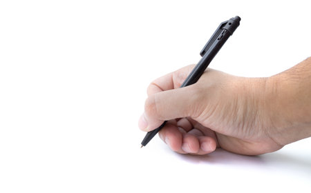 Hand writing on copy space. Male hand holding black pen isolated on white backgroundの写真素材