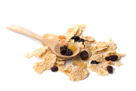 whole grain cereal flakes which mixed berry fruit and raisins for breakfast isolaed on white...