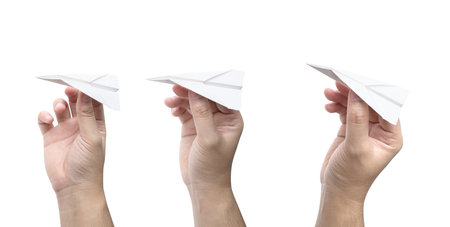 Hand holding a paper plane isolated on white backgroundの写真素材